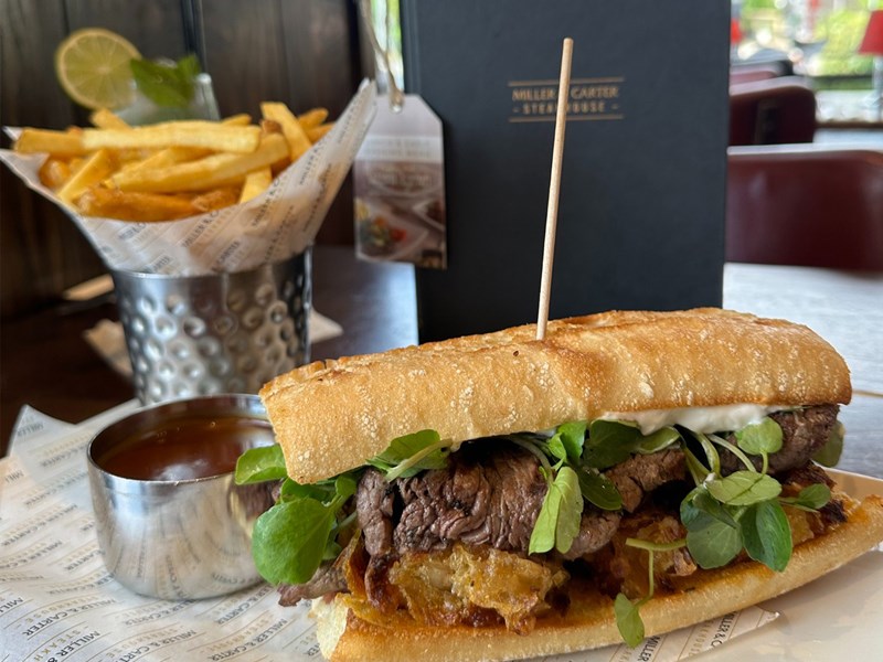 A steak sandwich with french fries at Miller & Carter Steakhouse.