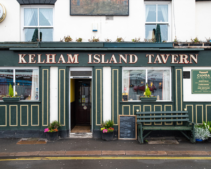 The exterior of the Kelham Island Tavern public house in Sheffield, painted in white green and gold.