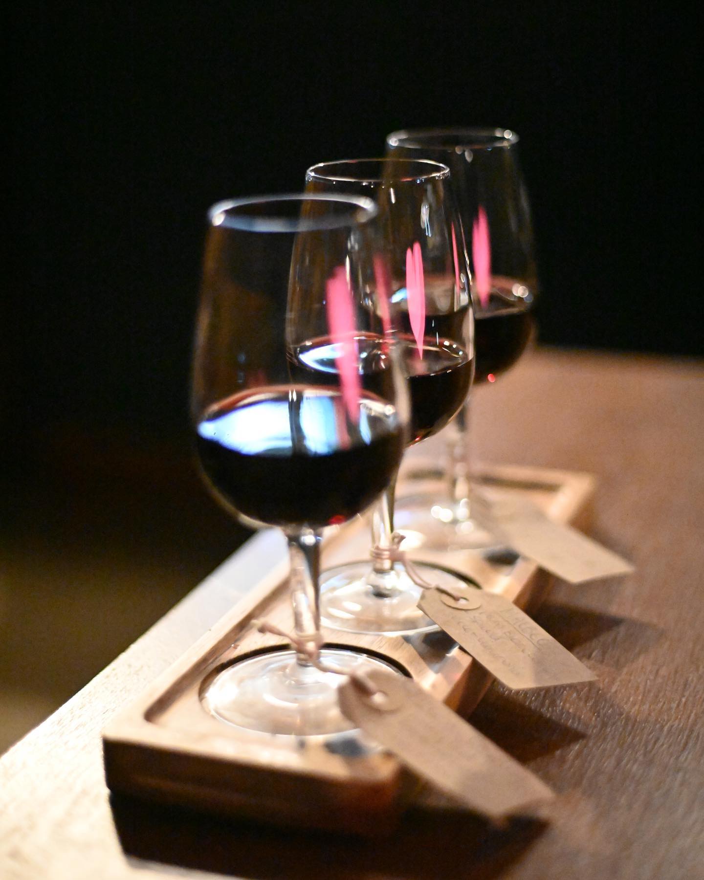 A row of filled wine glasses at True Loves.