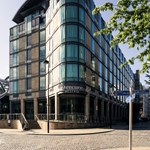 The corner exterior of the Mercure St Paul's Hotel on a sunny day