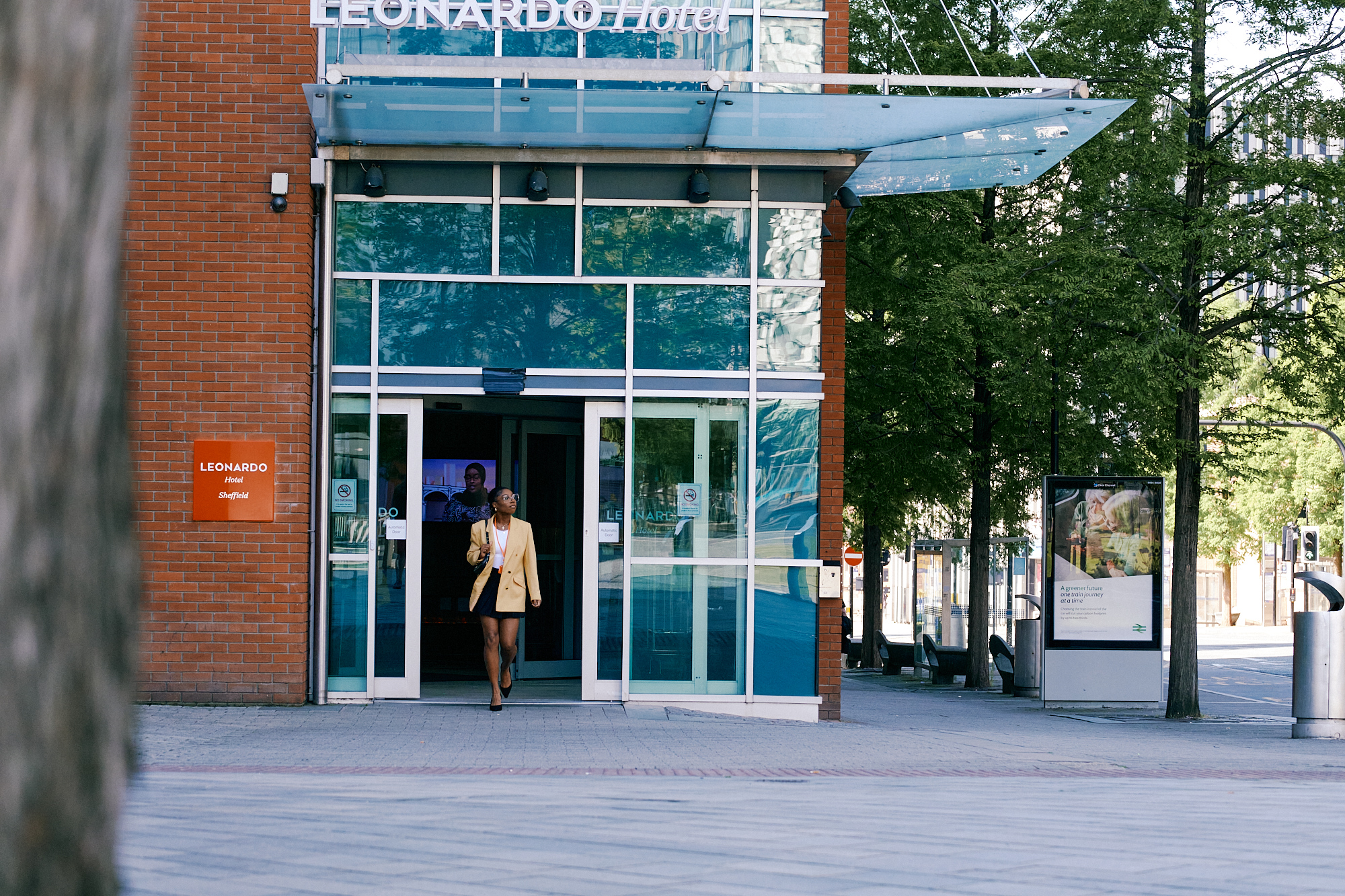A woman walks out of the main entrance to the Leonardo Hotel in Sheffield city centre.