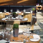 Elegantly set tables in the restaurant at Mercure St Paul's, featuring glassware and cutlery.