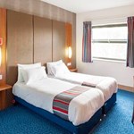 Interior of a twin room at Travelodge Sheffield Meadowhall with two single beds and modern furnishings.