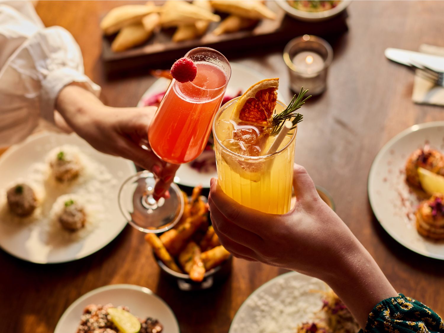 Two people dining at Cosy Club, and enjoying their cocktails.