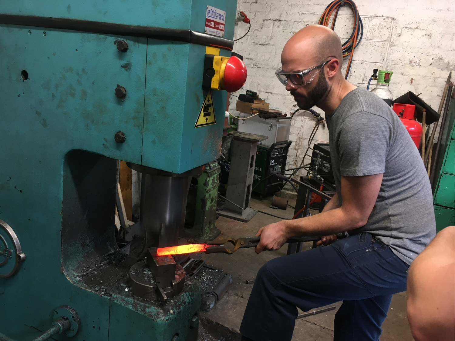 Two men hard at work in a forge.