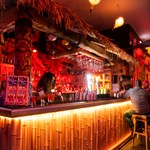 The bar, decorated in a Tiki style, at the Bamboo Door.