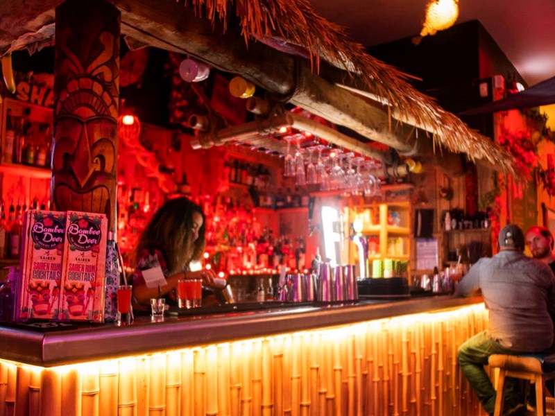 The bar, decorated in a Tiki style, at the Bamboo Door.