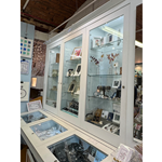 Glass display cases filled with various items for sale at All Good Stuff.