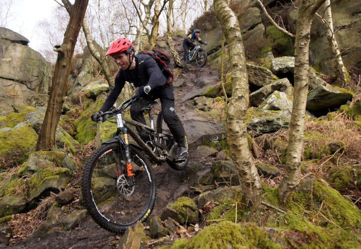 People mountain biking in the countryside.