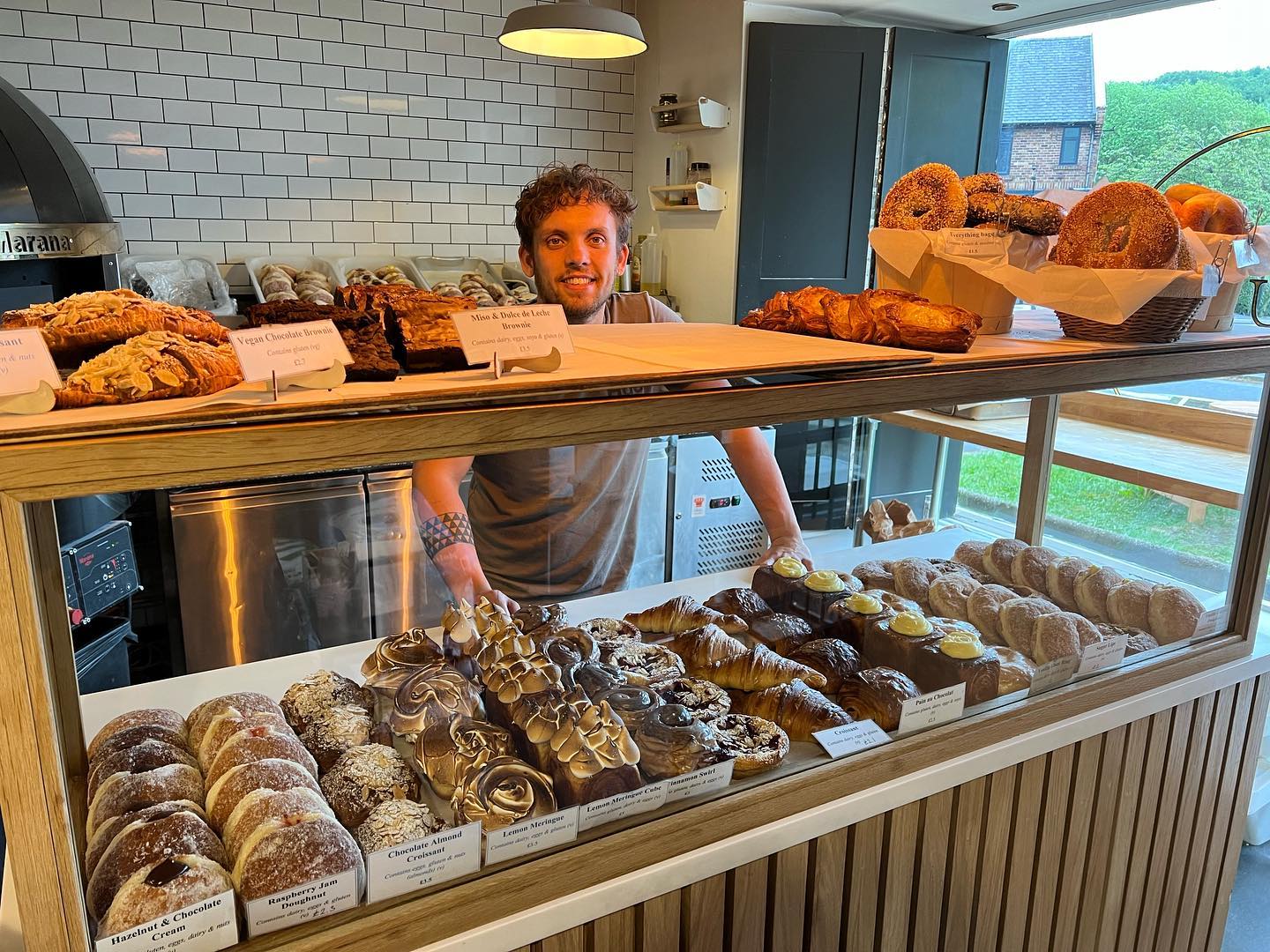 A member of staff stands behind the counter at Crumb.