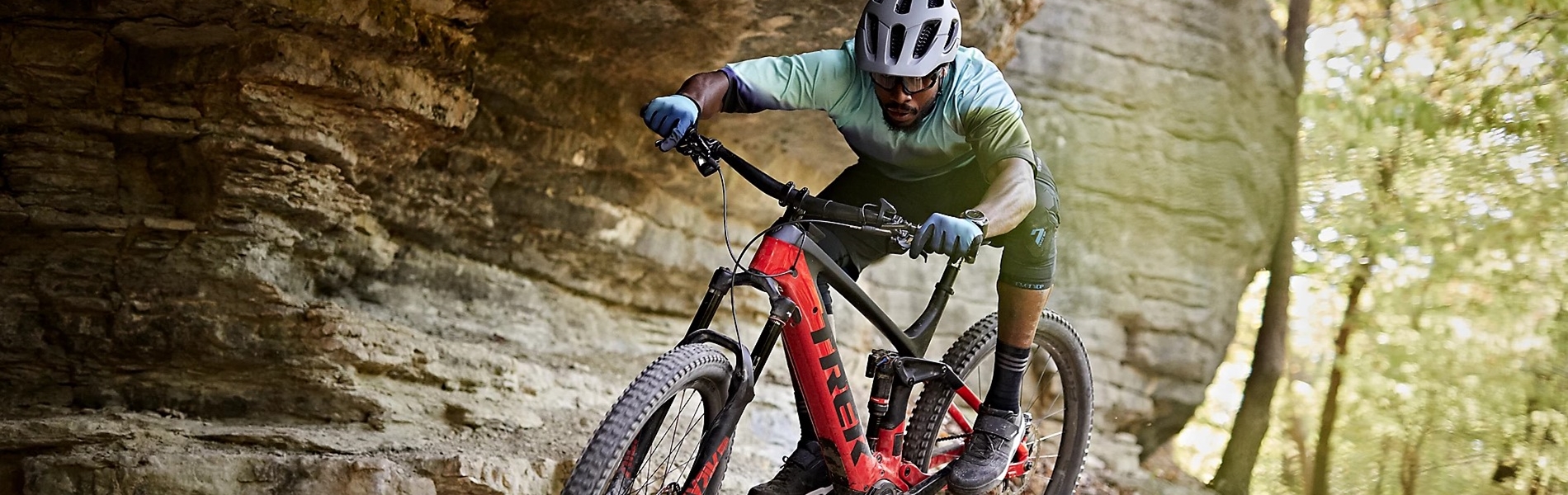 A man jumping off a rocky outcrop on a mountain bike at Trek Bicycle Sheffield Fox Valley.