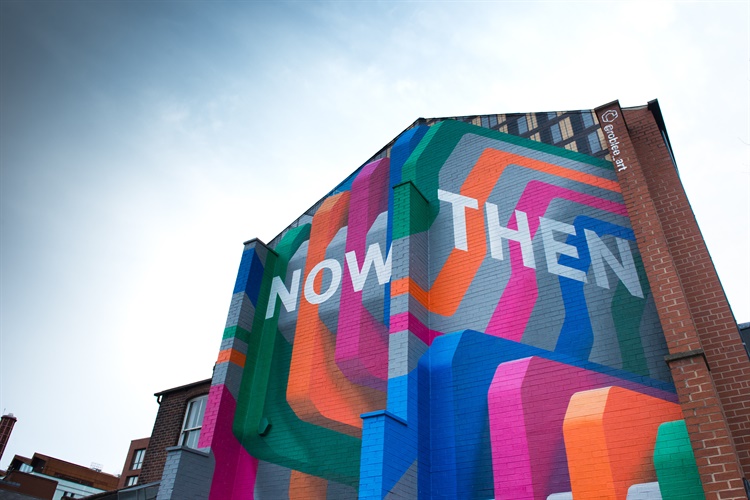 A huge colourful mural with the words 'Now Then' by Rob Lee, on Howard Street in Sheffield.