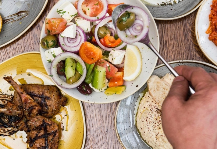 Plates of fresh Turkish food laid out on a table.