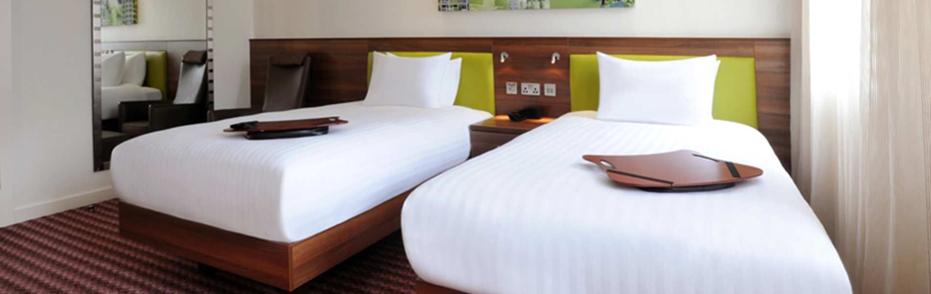 A hotel room with two single beds.