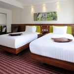 A hotel room with two single beds.