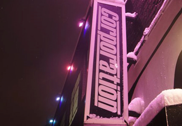 The Corporation sign on the side of the building.
