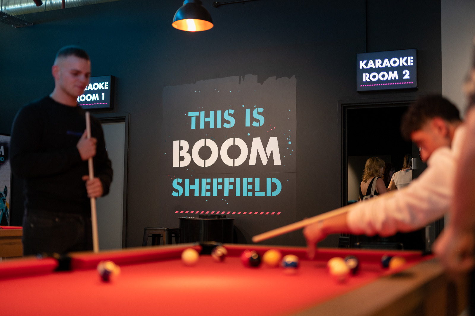 People playing pool at Boom Battle Bar.