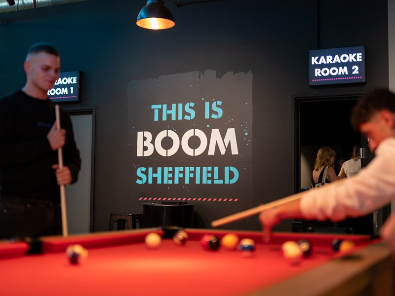 People playing pool at Boom Battle Bar.