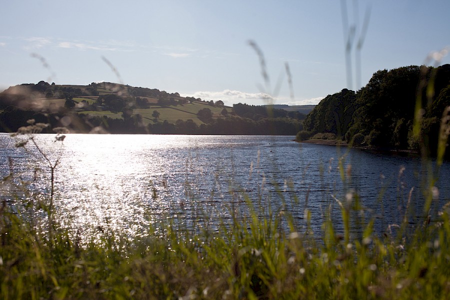 Bradfield Reservoir with the sun glinting off the water. 