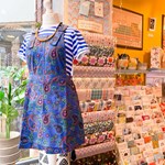 A mannequin wearing a blue paisley dress at Mookau.