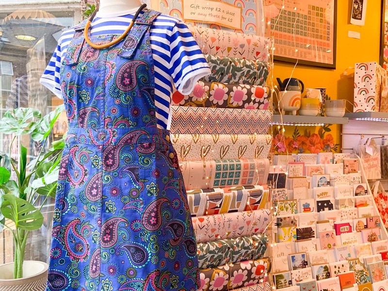 A mannequin wearing a blue paisley dress at Mookau.