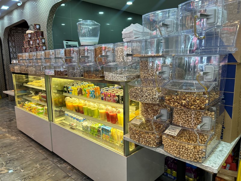 A glass display of the juice and nuts selection