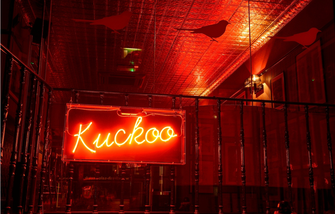 A red neon sign that reads 'Kuckoo'.