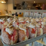 A tray of doughnuts filled with jam and cream.