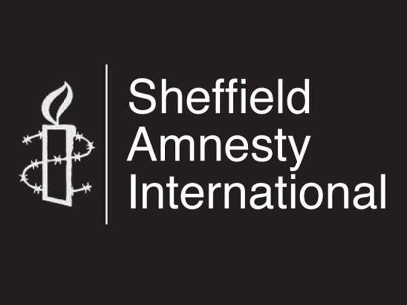The Sheffield Amnesty International logo which is a line drawing of a candle wrapped in barbed wire and the words Sheffield Amnesty International, all in white on a black background.
