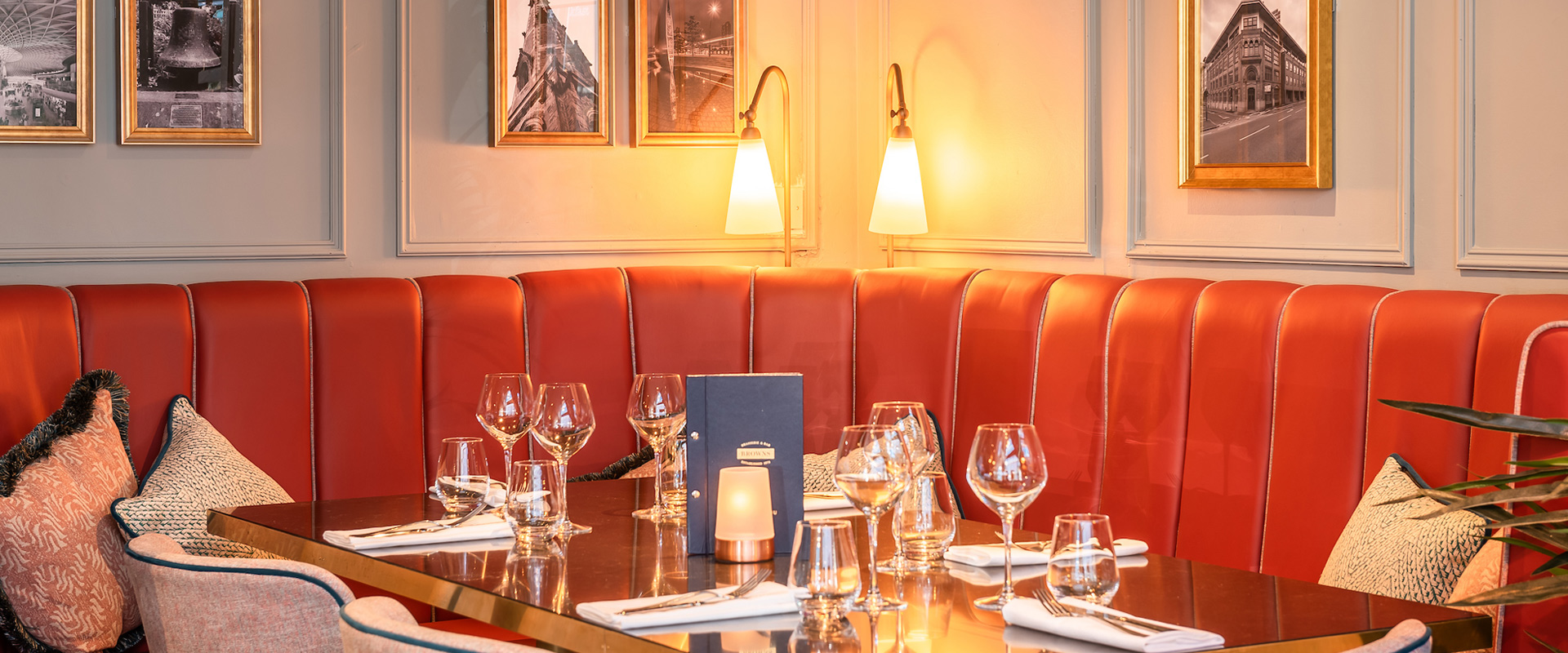 A booth at Browns Sheffield with red leather upholstery.