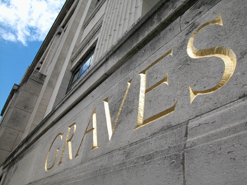 The word Graves carved into the stone fascia of the building.