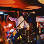 A band plays live at a small venue.