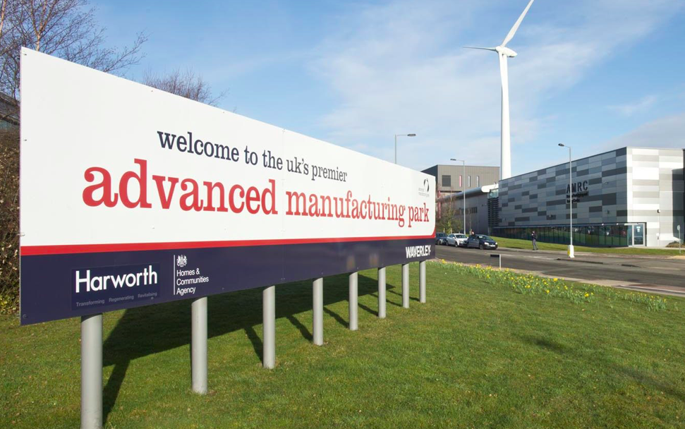 A large sign that reads 'Welcome to the UK's premier advanced manufacturing park'.
