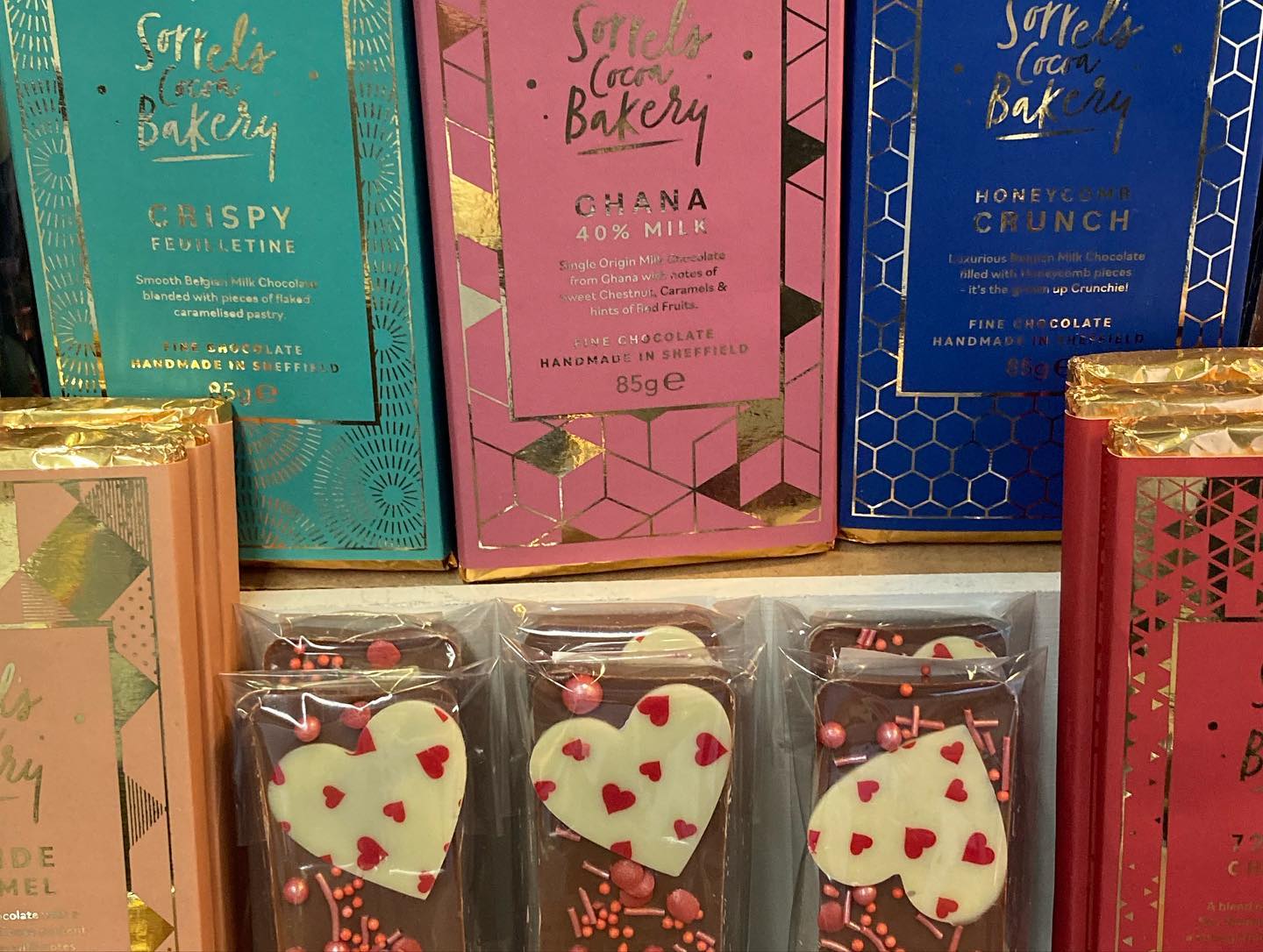 Chocolate and other goods on a shelf.