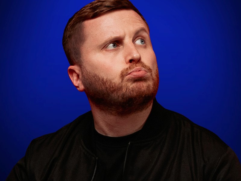 A head-shot of Josh Baulf pursing his lips.