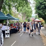 Crowds wander along stalls at the leafy Nether Edge Market