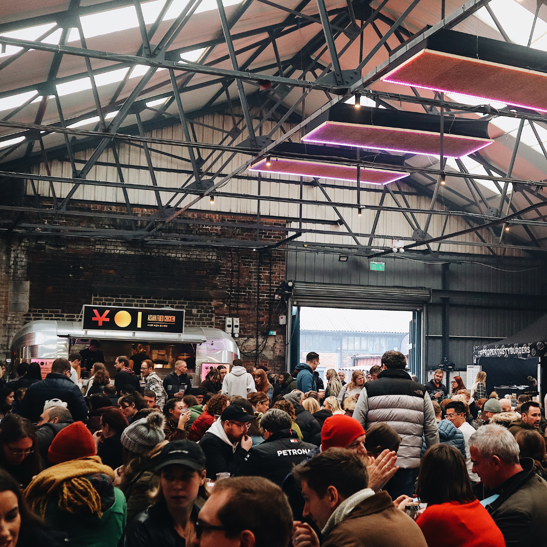 Peddler Market & Warehouse full of people sitting at long tables.