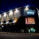 The exterior of ta Arena Sheffield lit up at night.