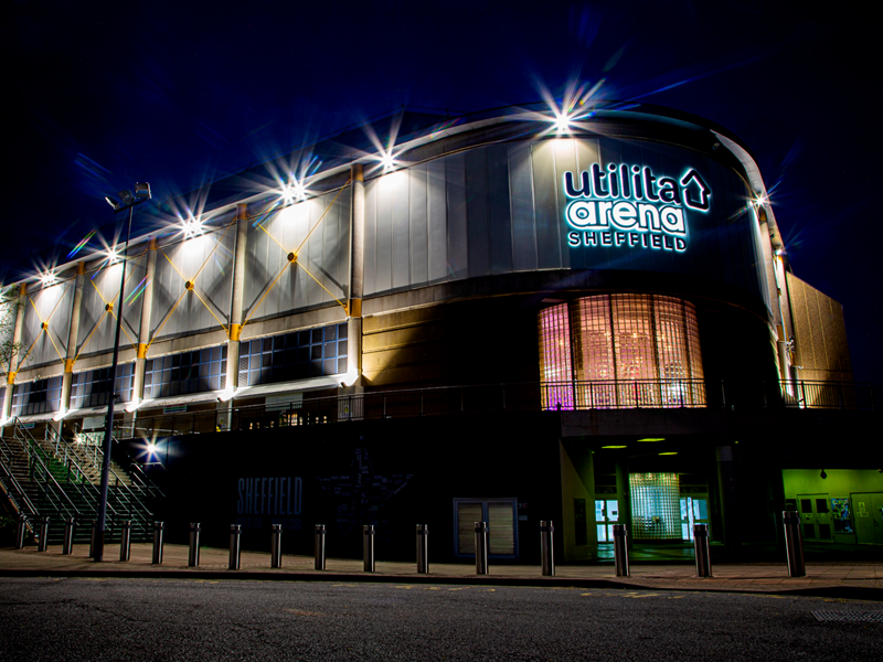 The exterior of ta Arena Sheffield lit up at night.