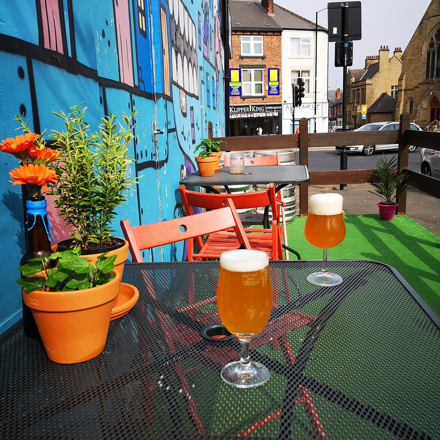 A table outside Jabbarwocky, with glasses of beer and pot plants.