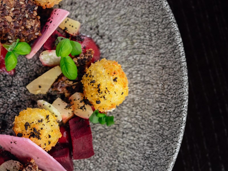 Food on a grey speckled plate.