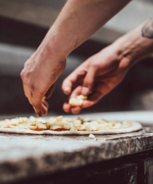 A pizza being prepaired.