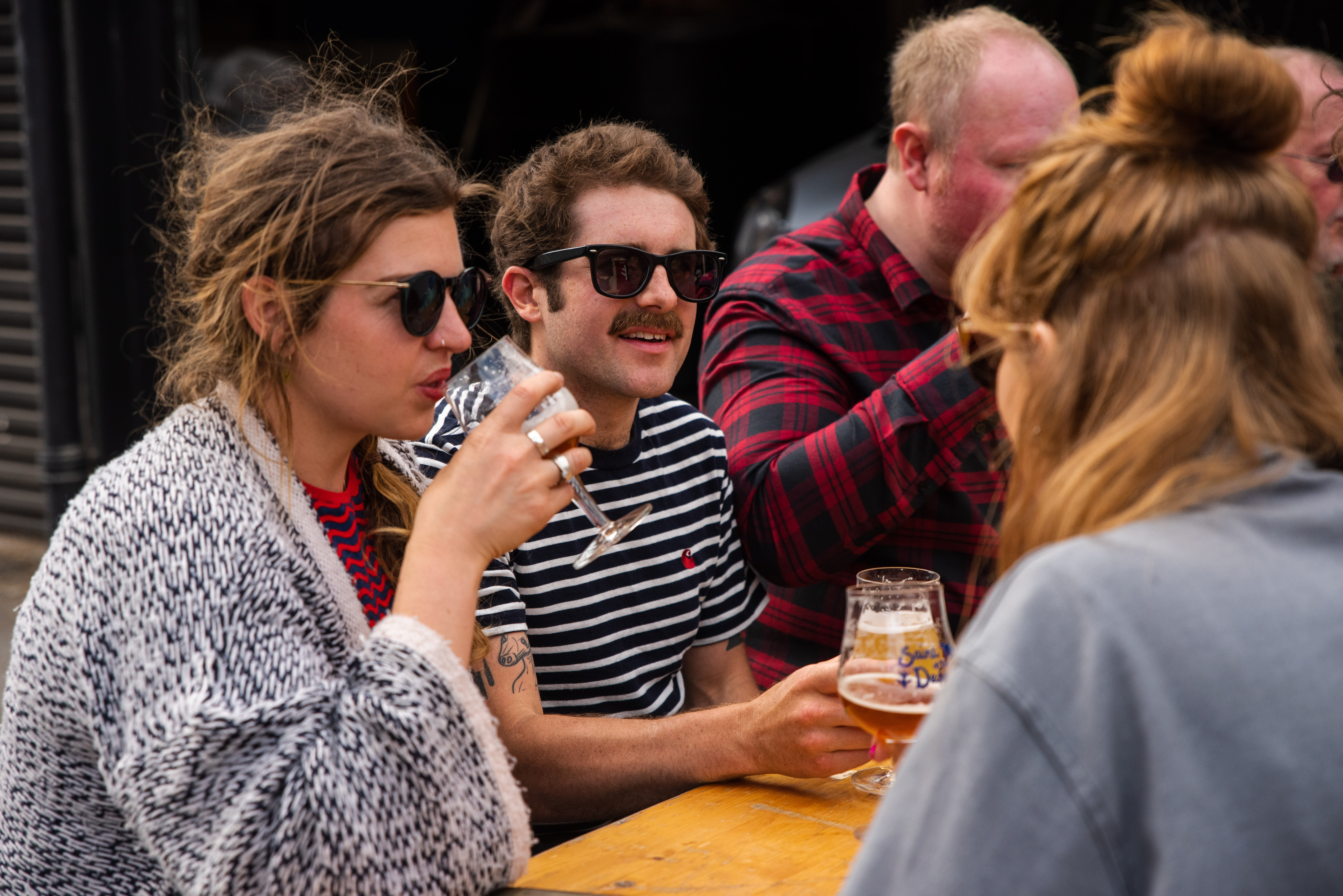 People enjoying a beer outdoors at The Brewery of St Mars of the Desert.