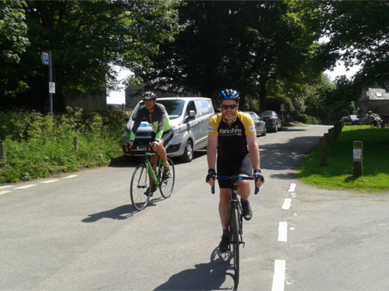 Two people road cycling.