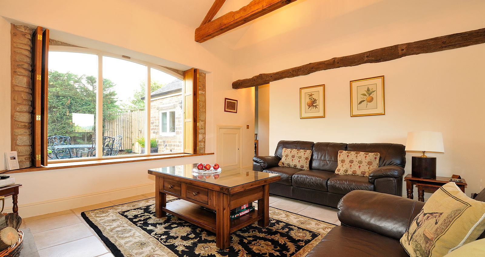 Bright living room featuring a large window with natural light, sofa, and coffee table.