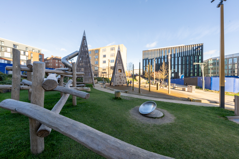 A view across Pound's Park, showing the play equipment and beches.