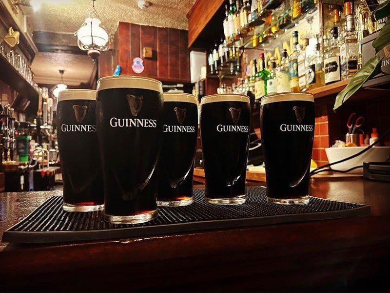 The bar at Fagan's with 5 pints of Gunniess.