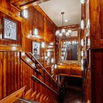 Wood panelled stairs heading down into Capone's Speakeasy.