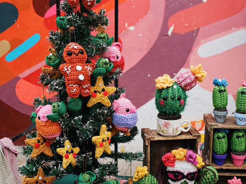 A stall selling crocheted Christmas decorations and cacti.