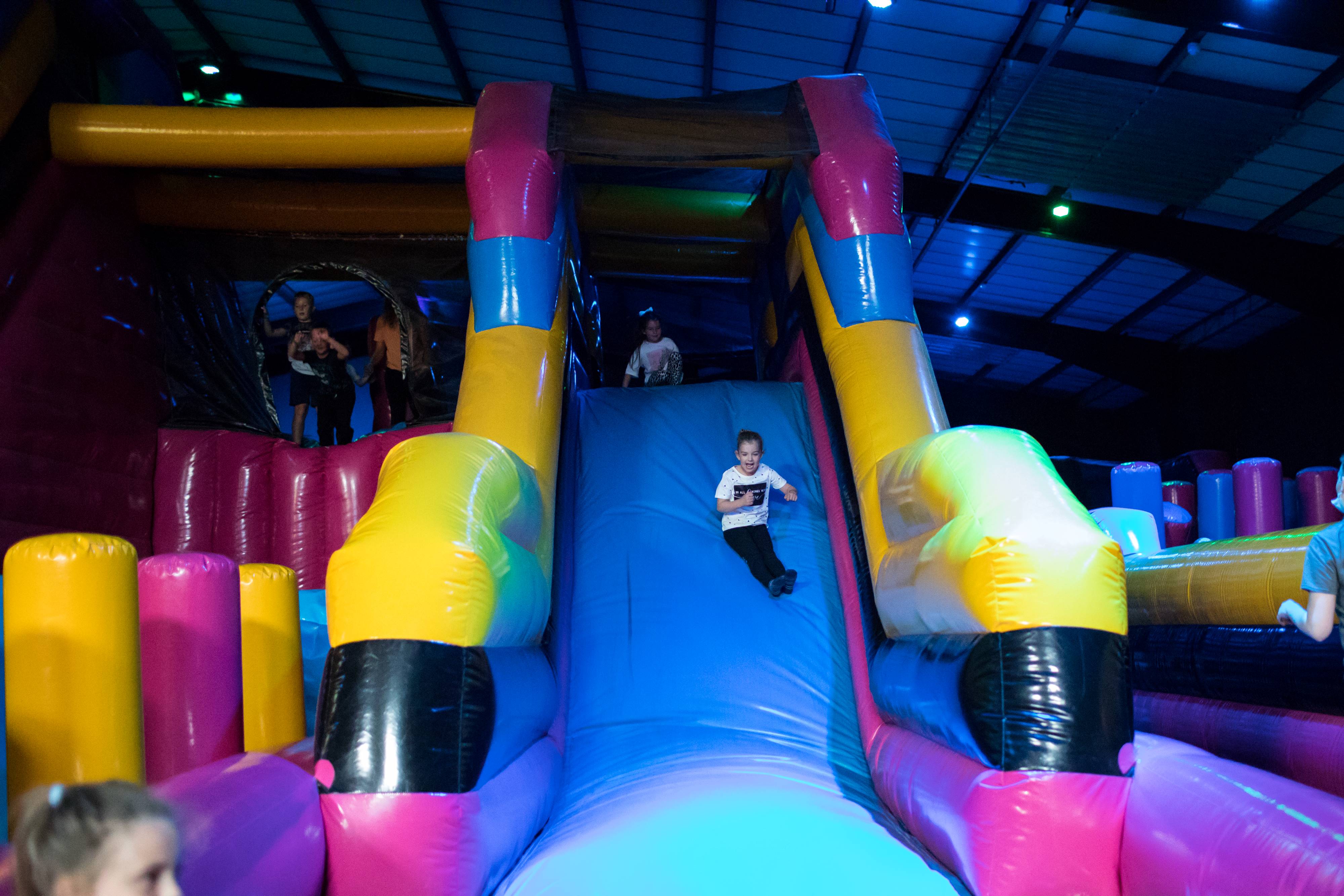 Children playing on a huge, inflatable slide at Air Haus in Sheffield.